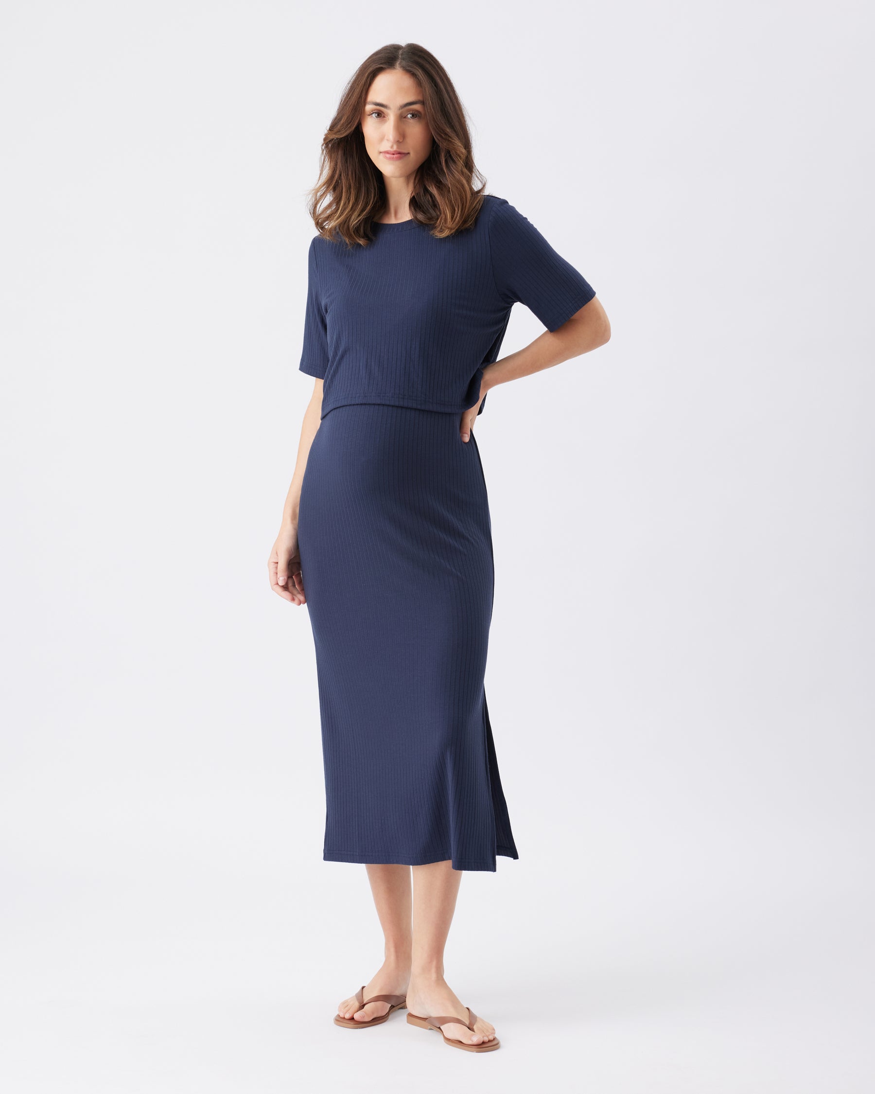 Woman wearing a navy blue dress on a white background