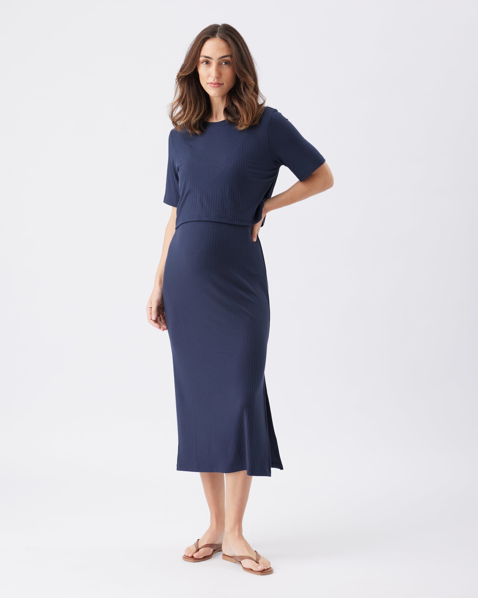 Woman wearing a navy blue dress on a white background
