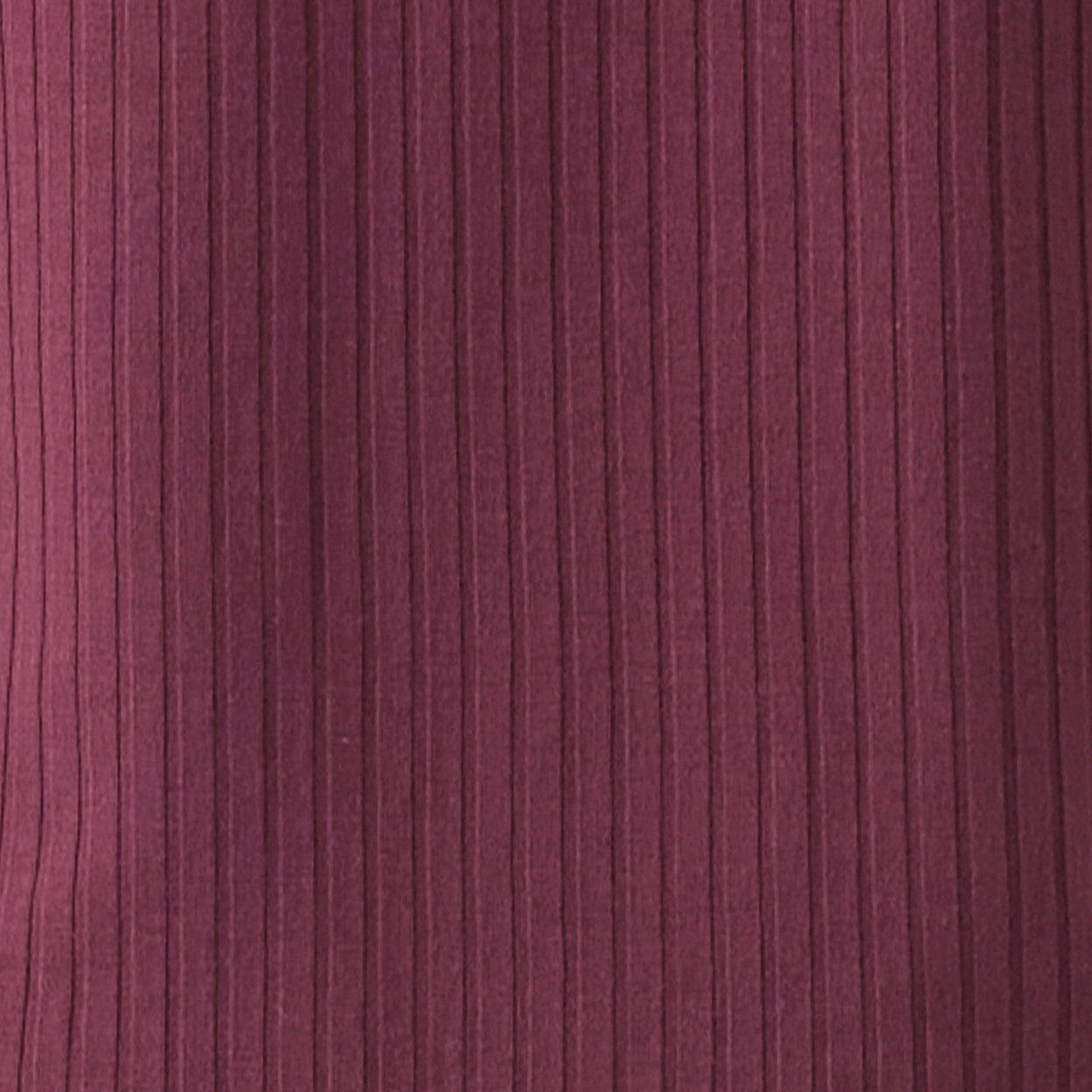 Close-up of a textured purple fabric with horizontal lines
