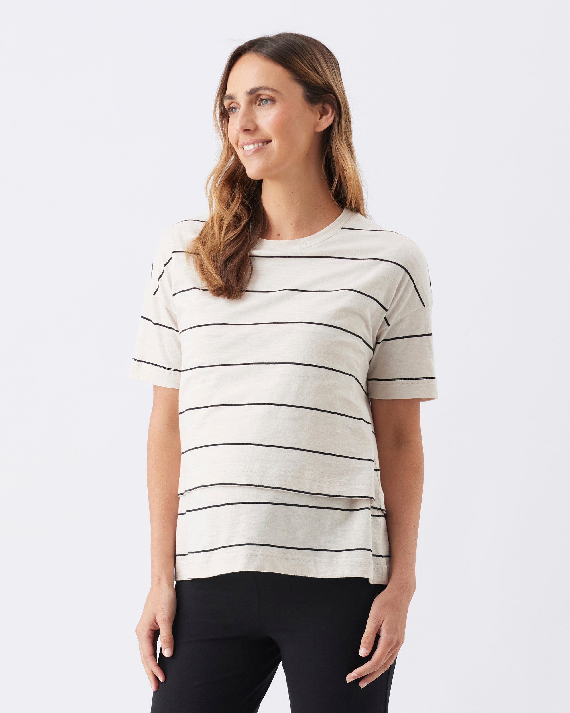 Woman wearing a striped shirt on a plain background