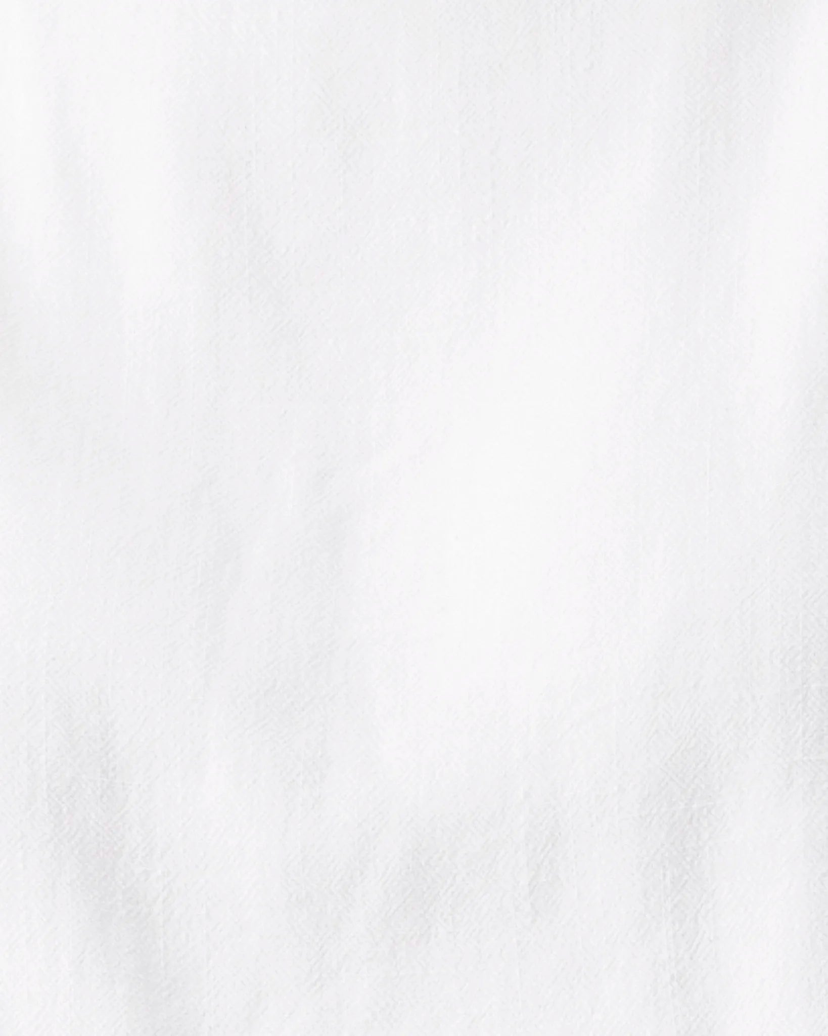 A close-up of a white textured fabric surface with soft folds and a slightly matte finish.