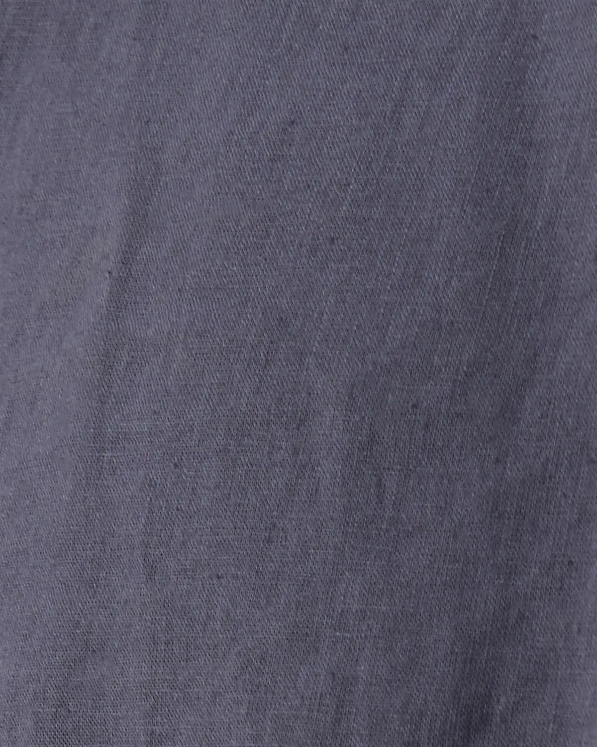 A close-up of a textured fabric in a muted slate blue or gray-blue color, showing the weave and soft folds.