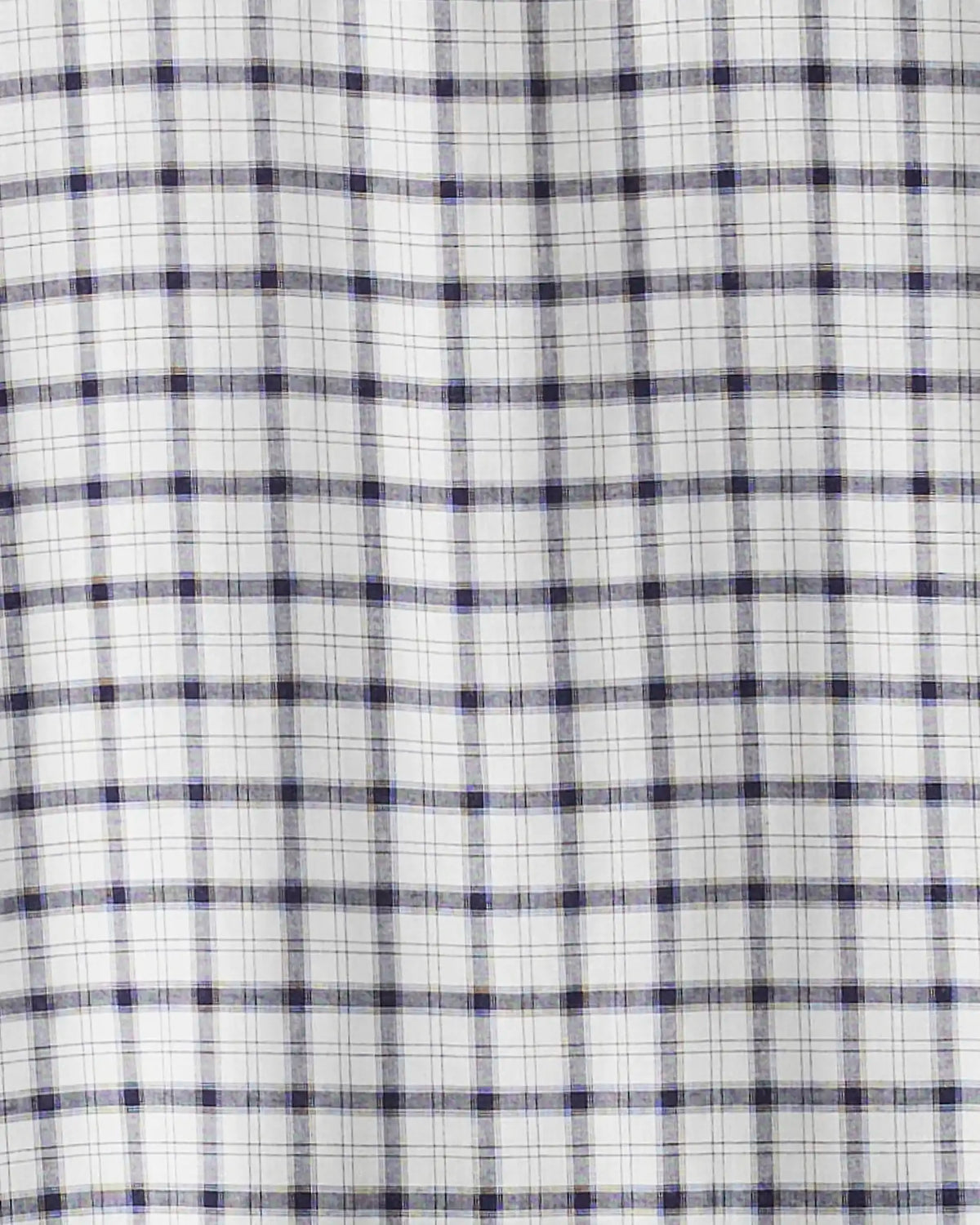A close-up of a white fabric with a blue and gray plaid pattern.