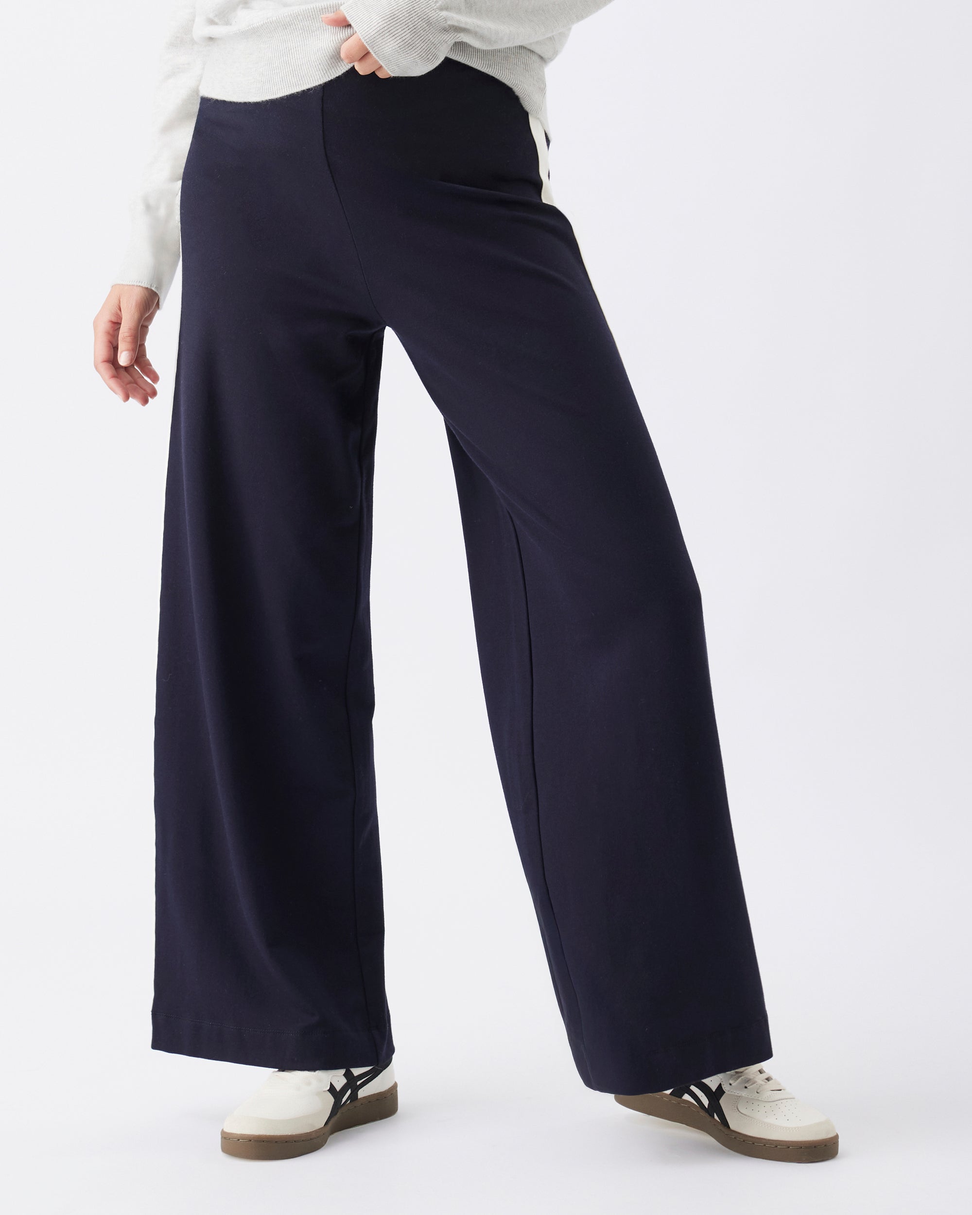 Navy wide-leg pants worn by a pregnant woman on a white background
