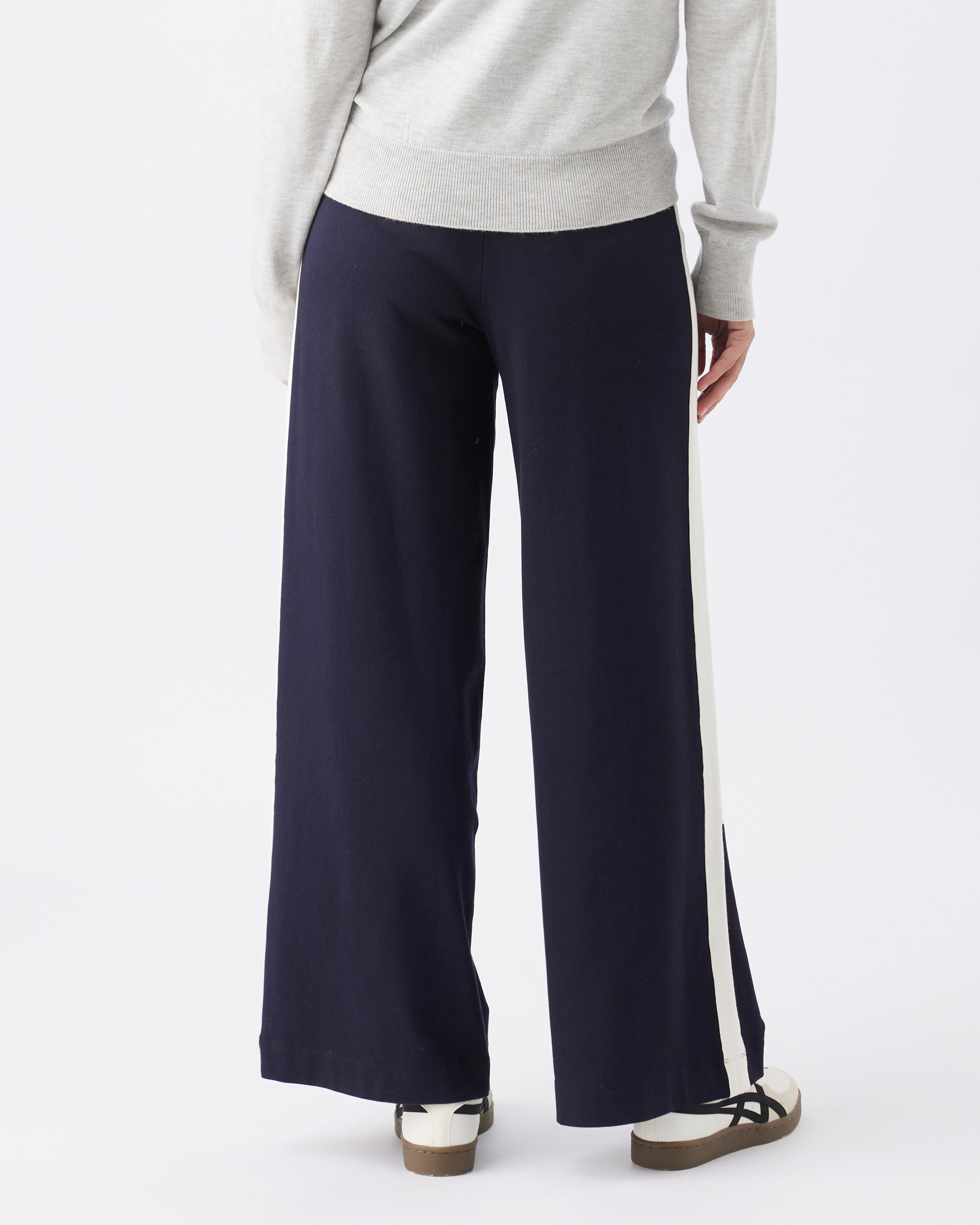 Navy wide-leg pants worn by a person on a white background