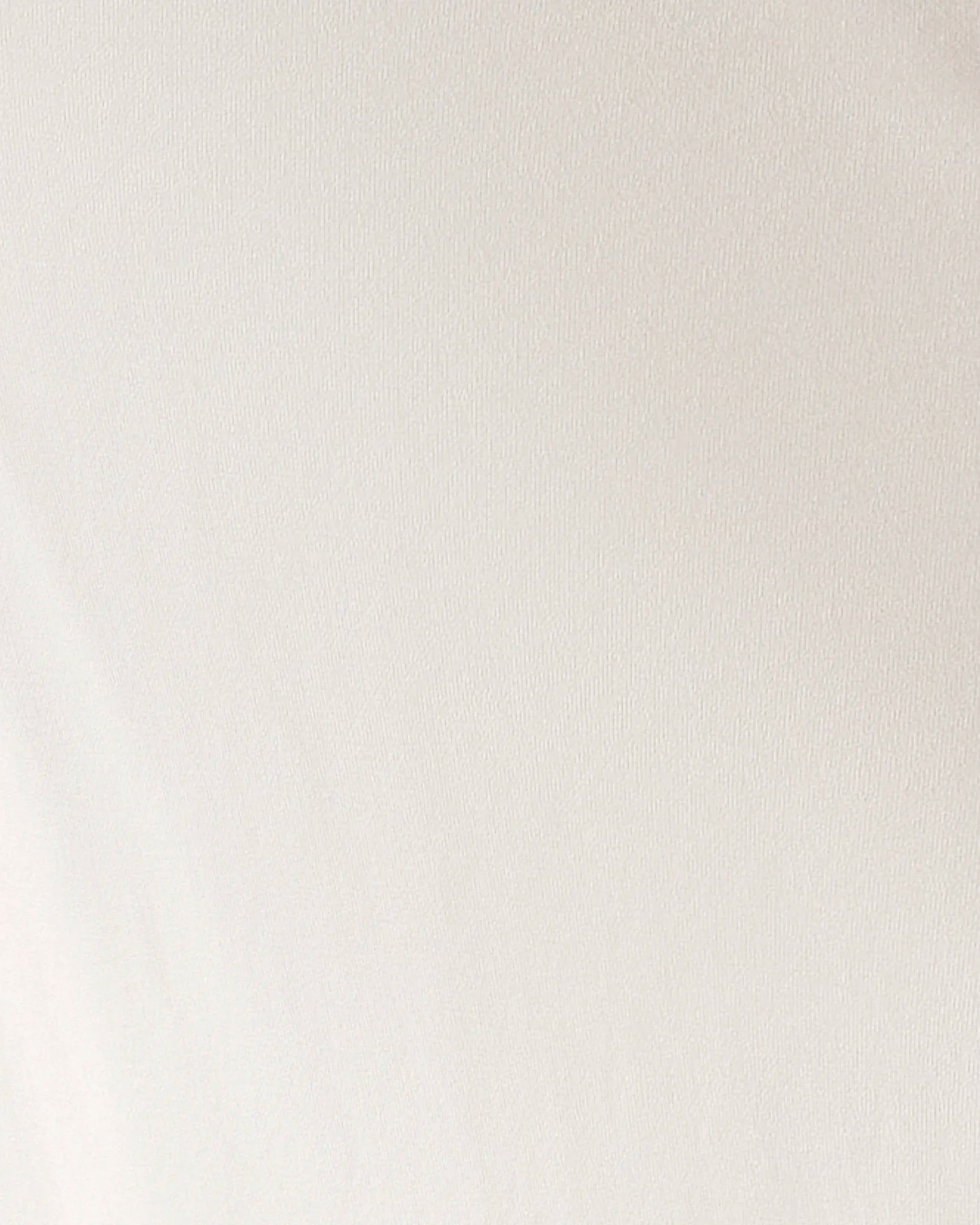 A close-up of a plain off-white or cream fabric surface with subtle texture and no visible product shape, person, or environment.