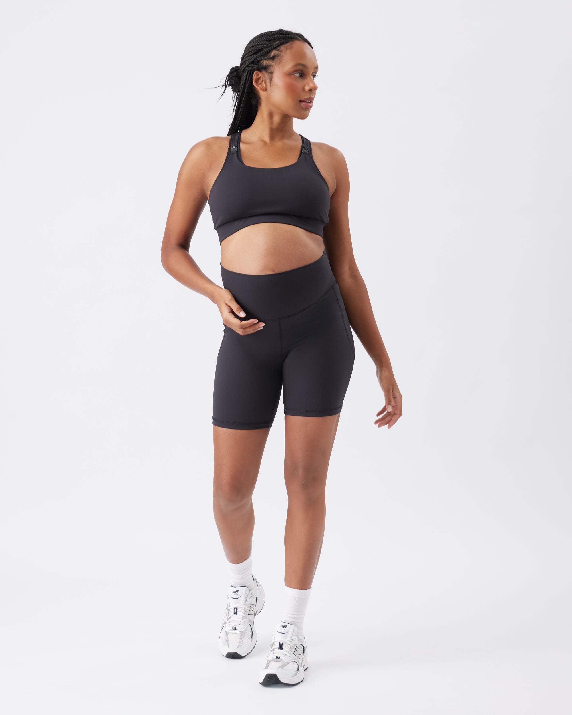 Woman wearing a black athletic outfit on a white background