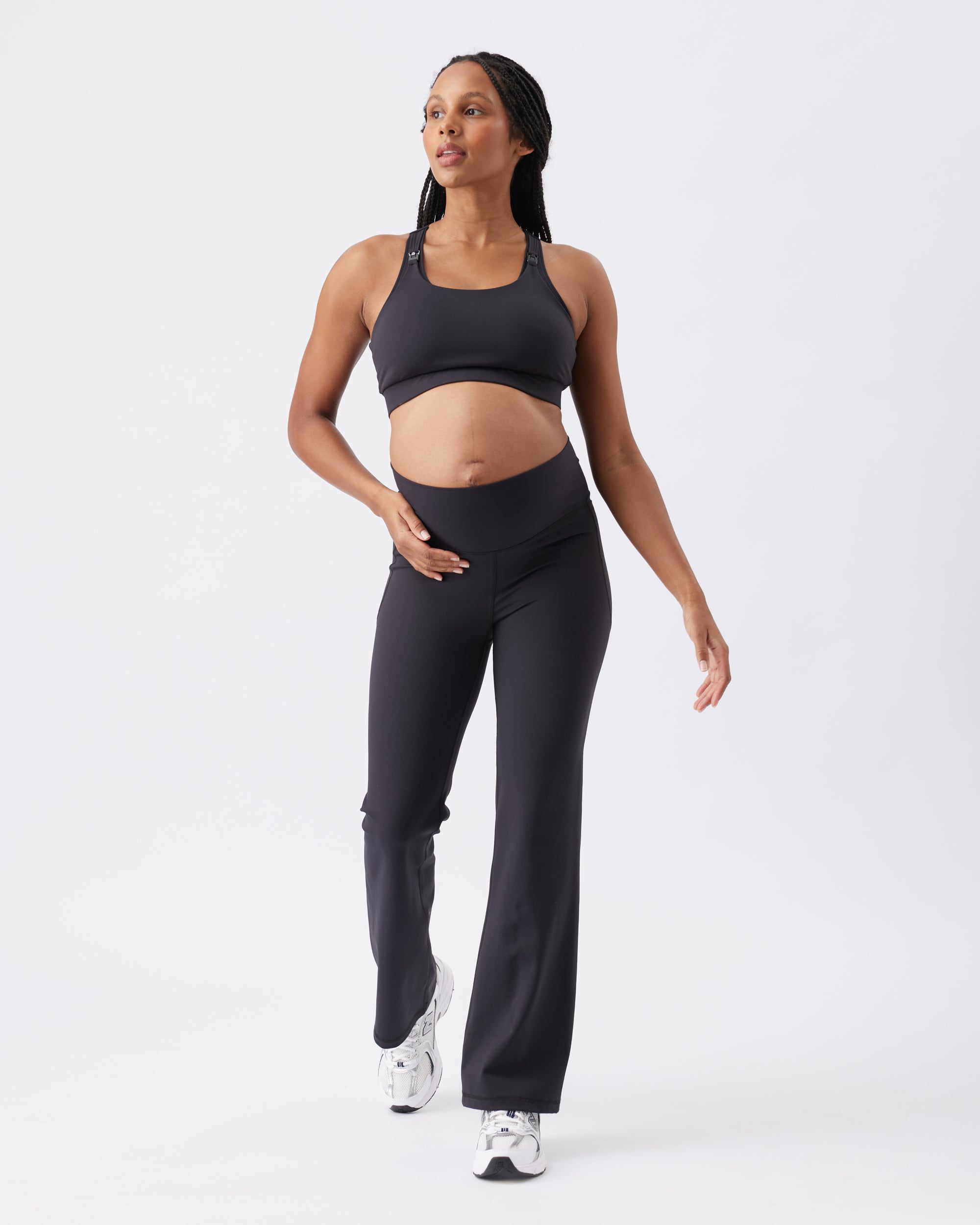 Woman wearing a black athletic outfit on a white background
