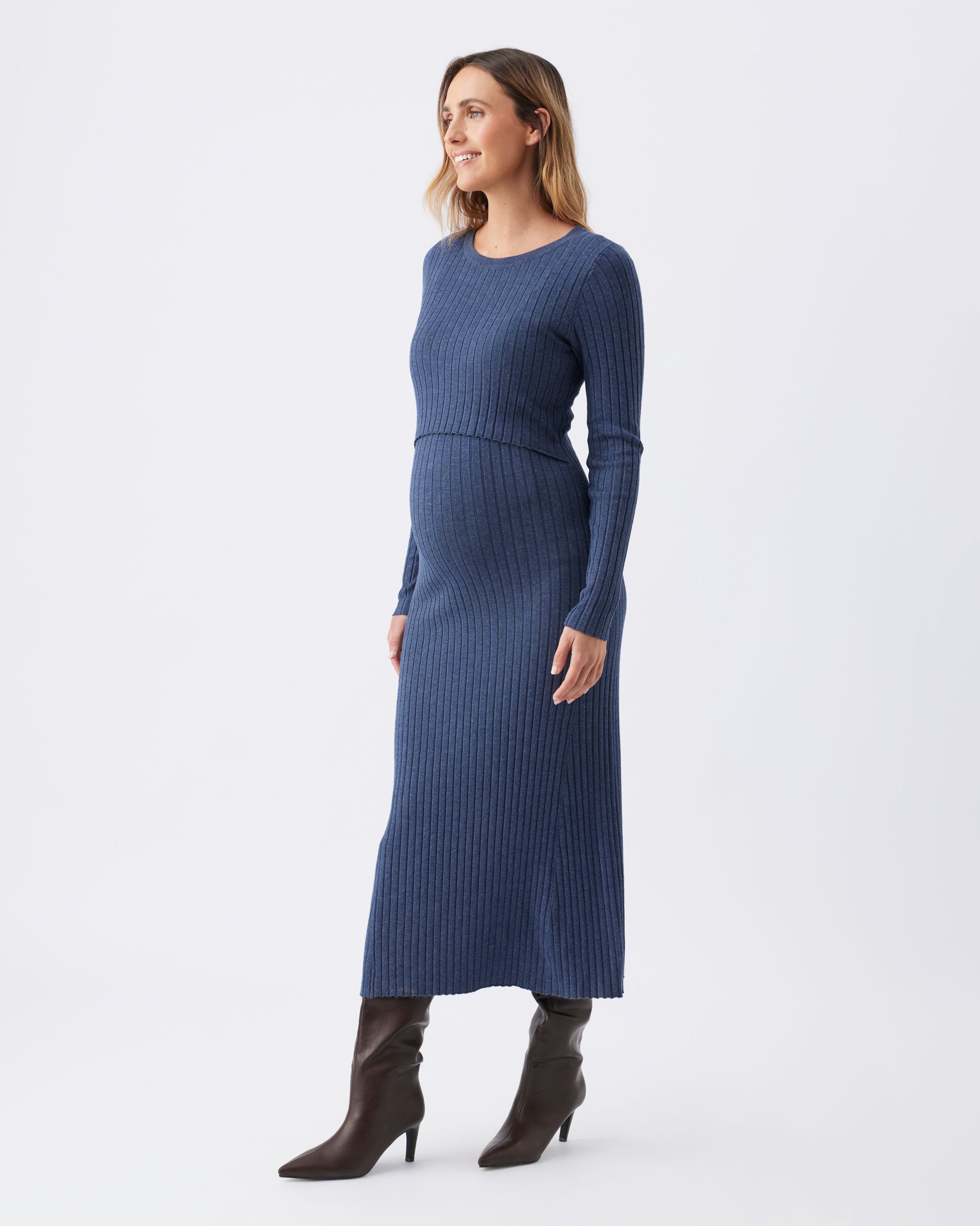 Side angle of a woman wearing a long sleeve blue ribbed nursing dress.