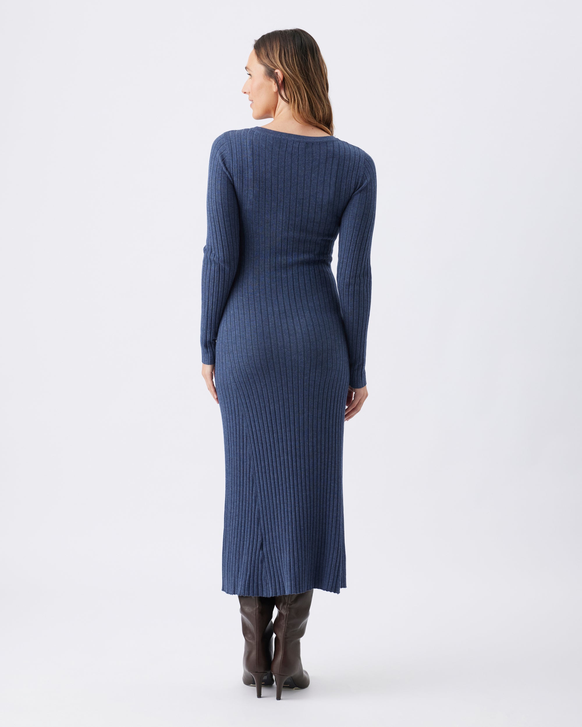 Back view of a woman wearing a midi length blue winter knit ribbed dress.