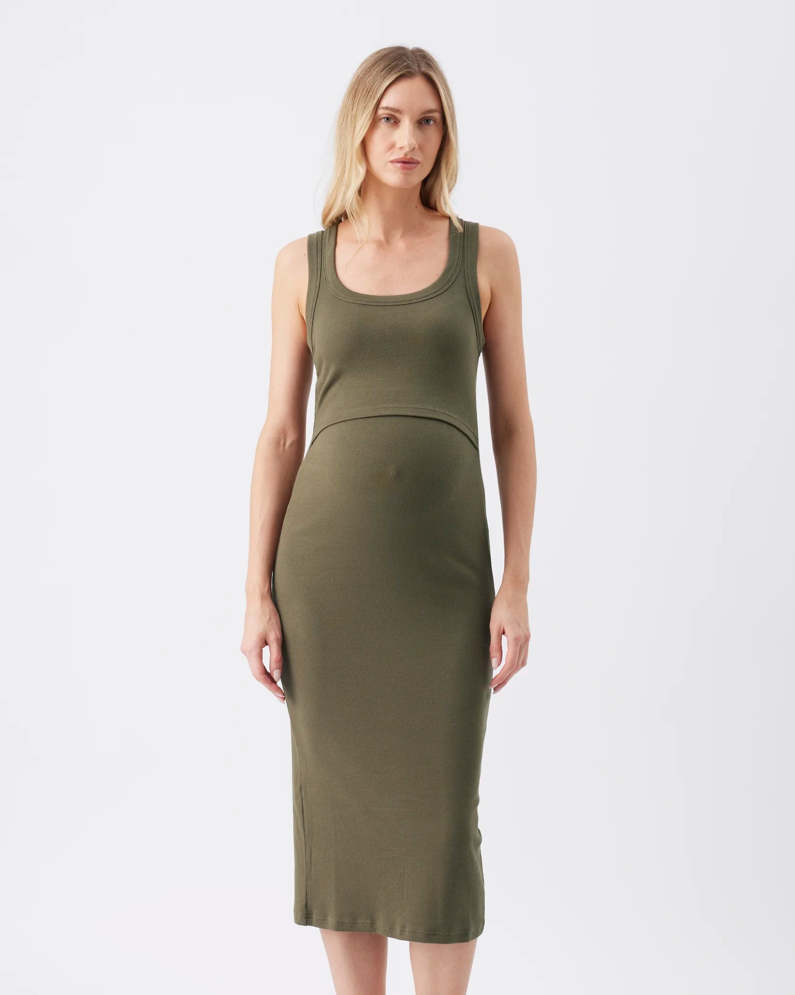 A woman modeling a ribbed, sleeveless scoop-neck midi dress in olive green against a plain white studio background.