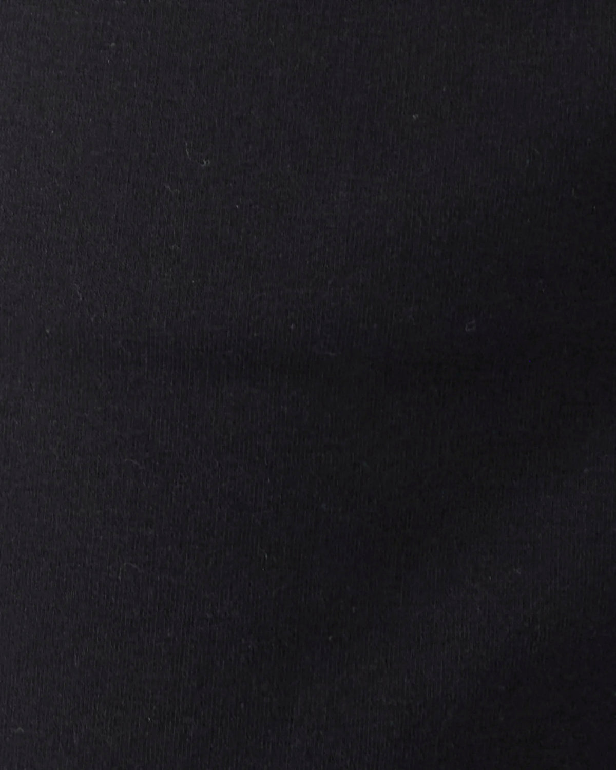 A close-up of a solid black textured fabric surface.