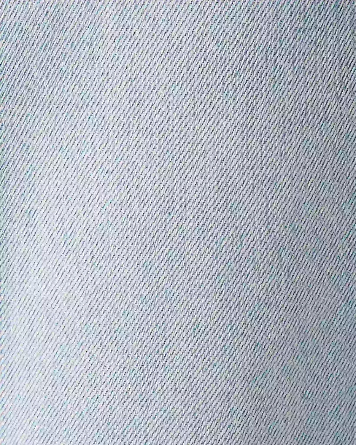 A close-up texture shot of light blue denim fabric, showing the detailed twill weave pattern.