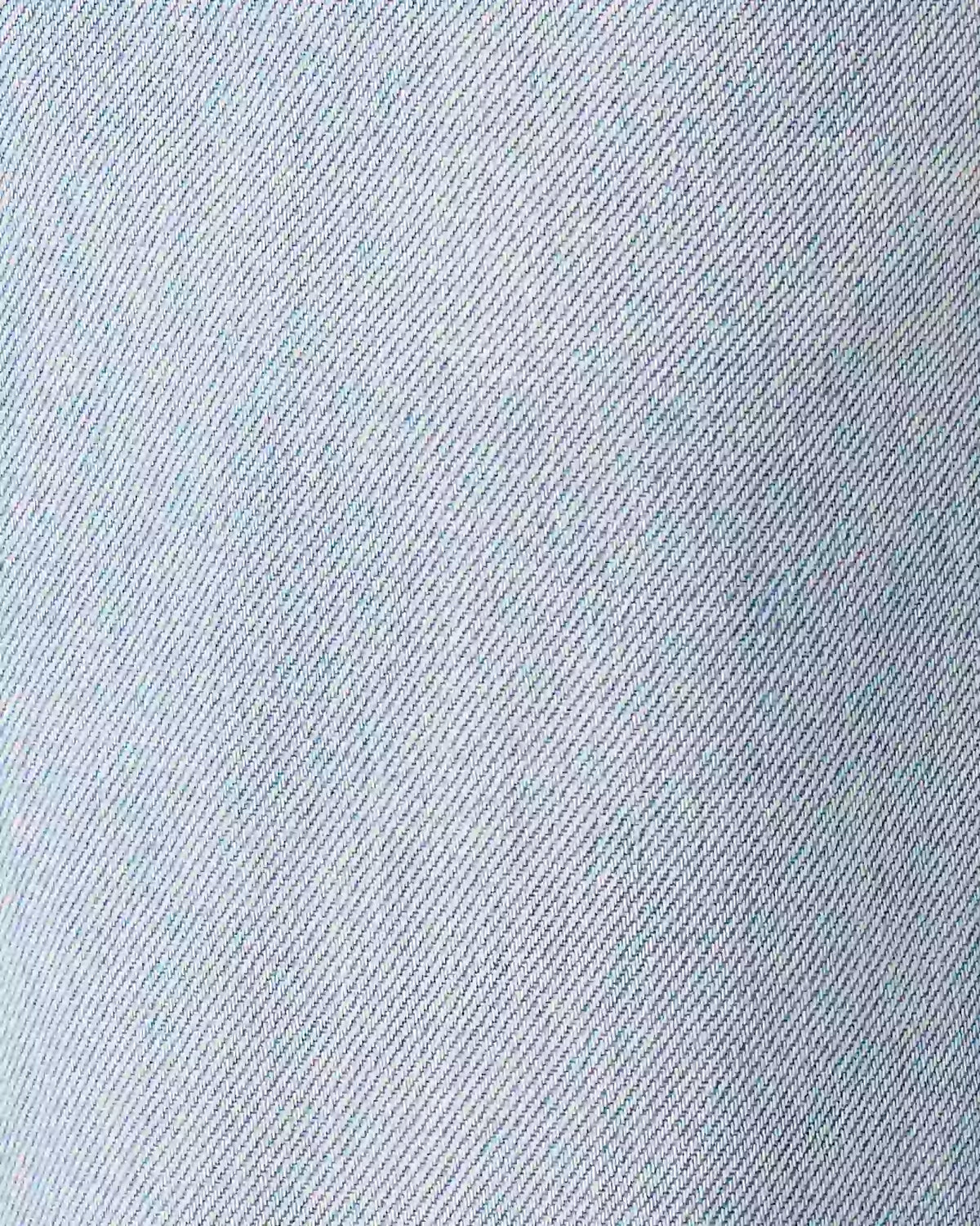 A close-up texture shot of light blue denim fabric showing the twill weave pattern.