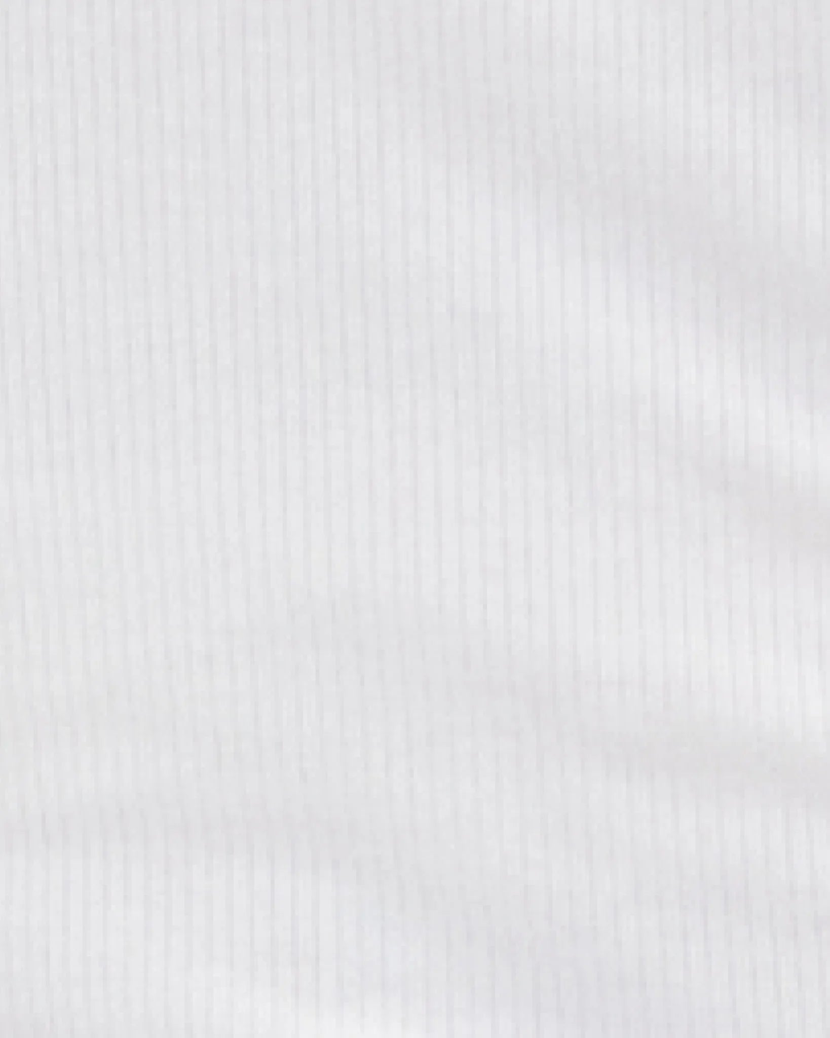 A close-up of a white ribbed fabric texture with fine vertical stripes.