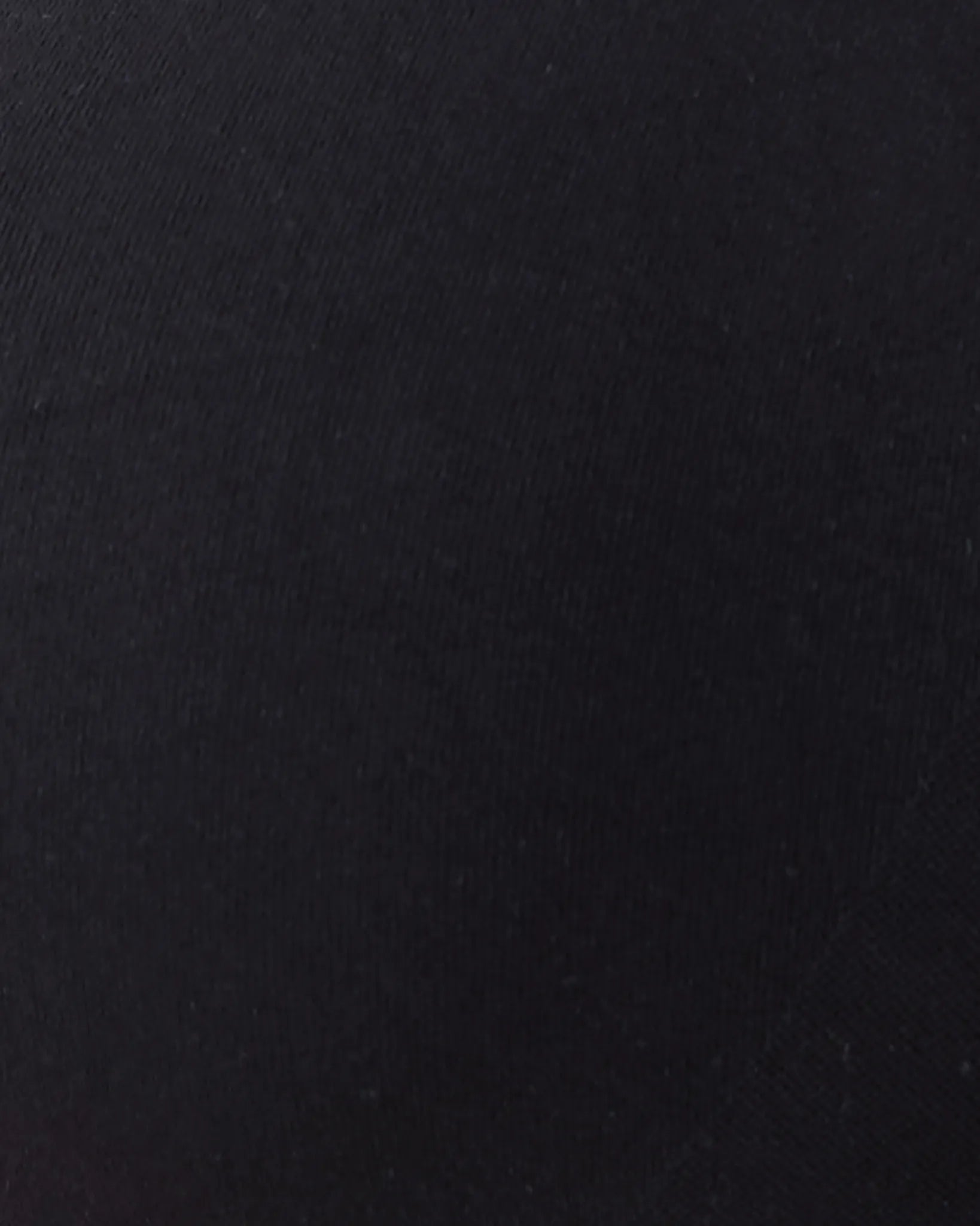 A close-up of a solid black textured fabric surface.